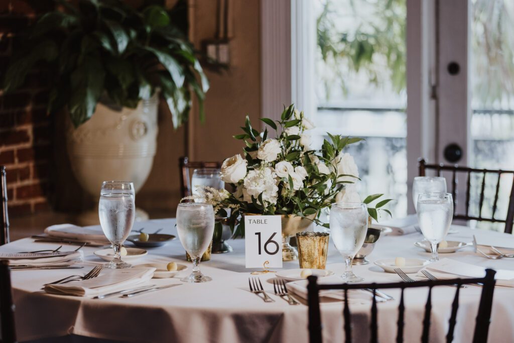white florals and greenery centerpiece at wedding reception