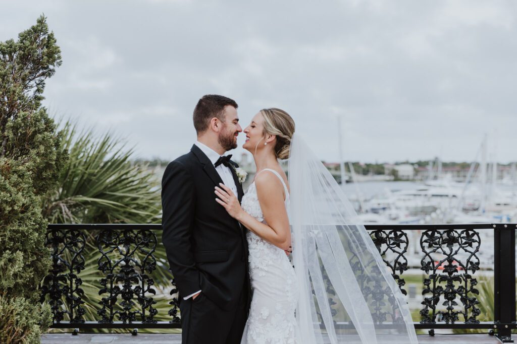 groom and bride together on rooftop of white room with view of downtown st. augustine
