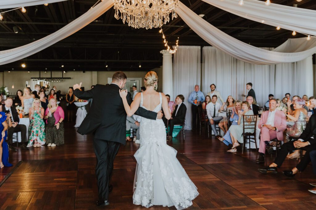 groom and bride dancing together on the grand ballroom dance floor 