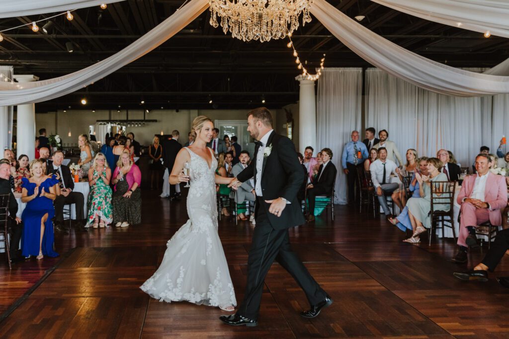 Bride and Groom dancing together on the dance floor of the reception in the grand ballroom of the white room
