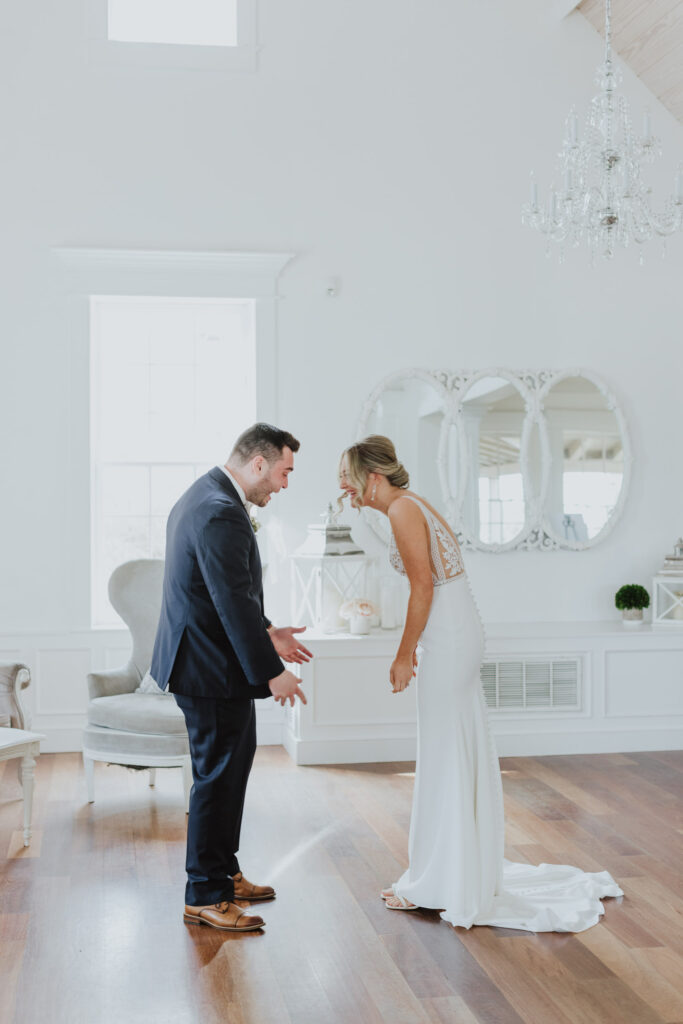 groom seeing bride for first time during their first look at the white room villa blanca space.
