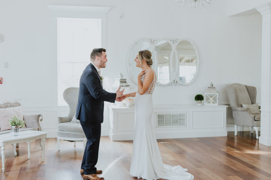the groom and bride looking at each other taking it all in while standing in the villa blanca ceremony space for the white room 