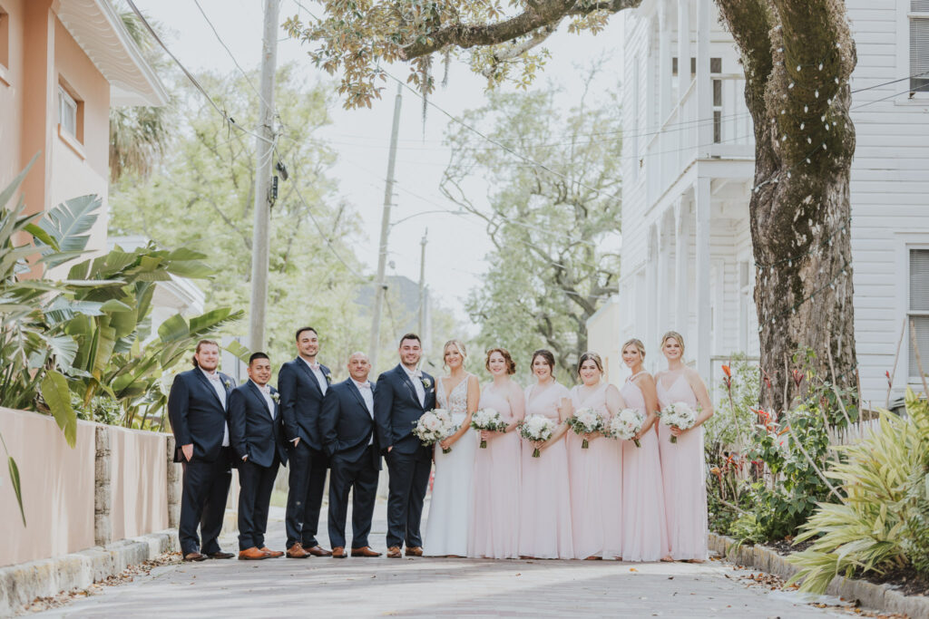 wedding party arranged in a line for portrait in the st. augustine streets